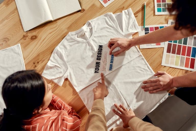 Team reviewing a custom design on apparel with color swatches